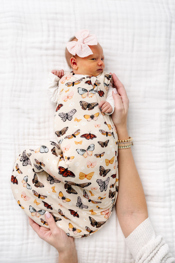 amelia sleep sack newborn girl laying on bed