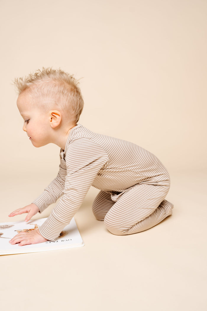 banks toddler boy zipper footies playing on the ground
