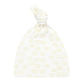 A beige top knot hat with a floral pattern
