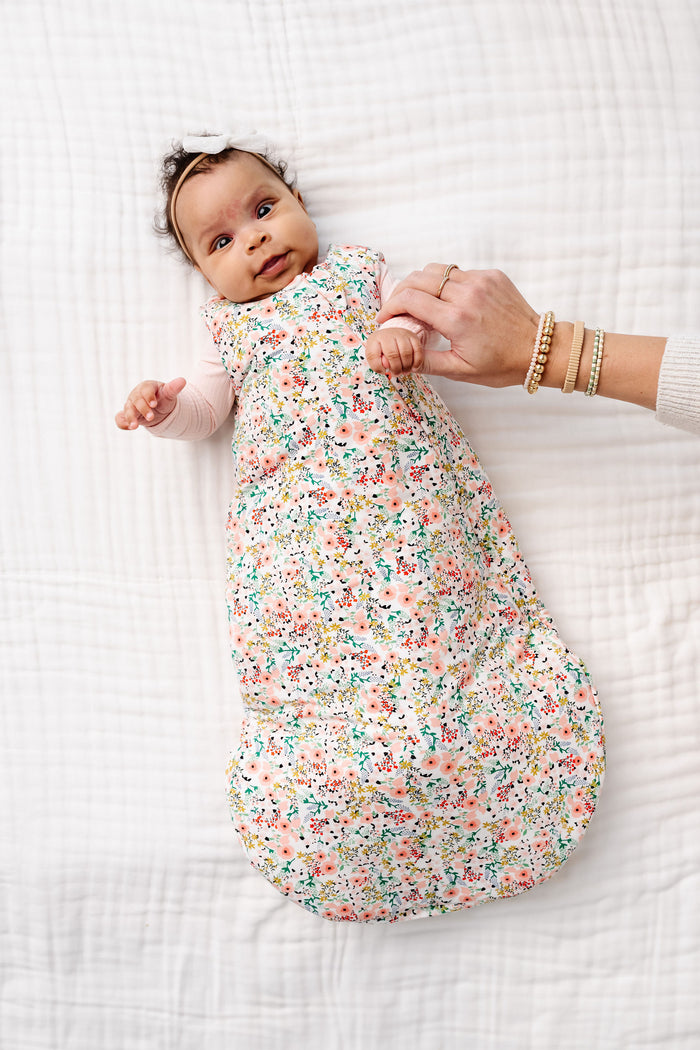 millie sleep sack newborn laying on bed