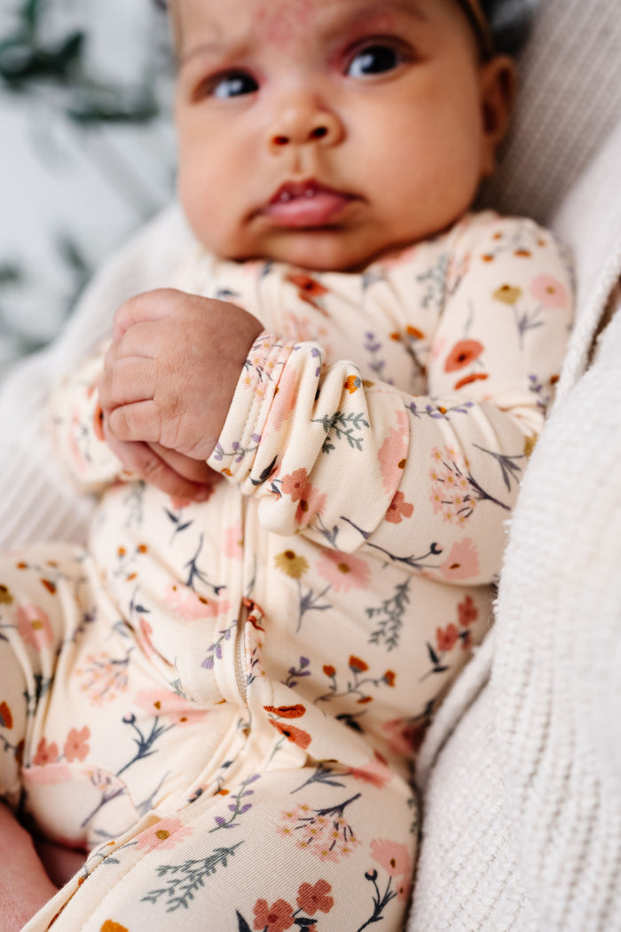 rachel zipper footies close up on print and zipper.